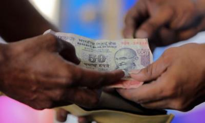 Rupee slips to record low