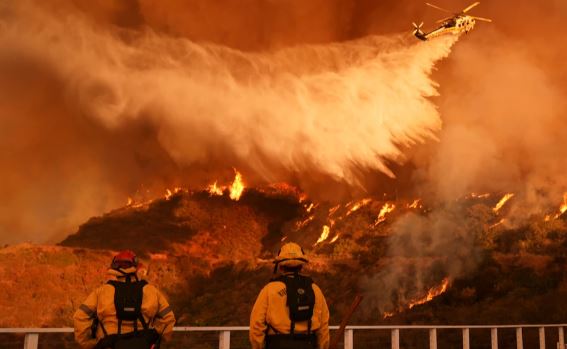 LA wildfire death toll rises as crews fight strong winds to protect homes, landmarks