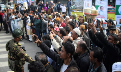 Through cold and fog, mourners gather to bid farewell to Khaleda