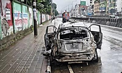 2 dead after private car catches fire following collision with road divider