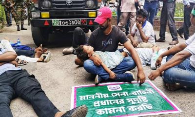 Agitating soldiers block army vehicles using child as shield