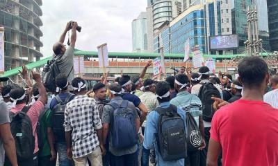 Workers barred from going to Malaysia block road in Kawran Bazar
