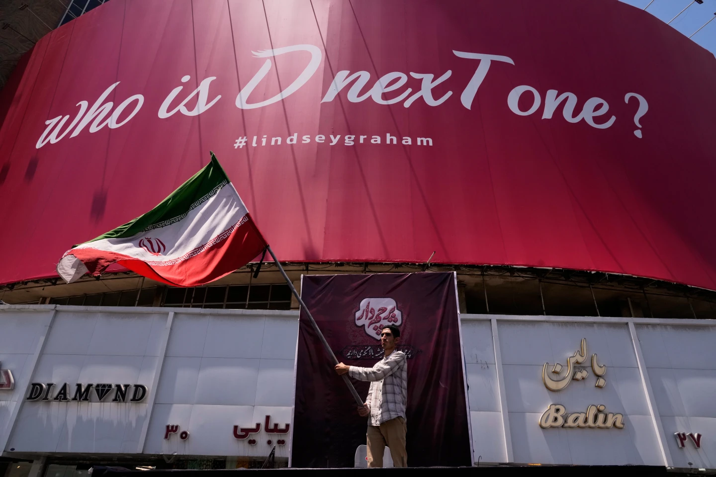 US strikes bridges and collapses a tower at a key port as its Iran campaign expands