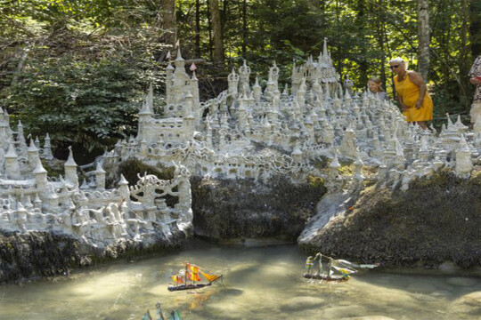 Swiss artist sculpts sprawling model castle on dried river bank