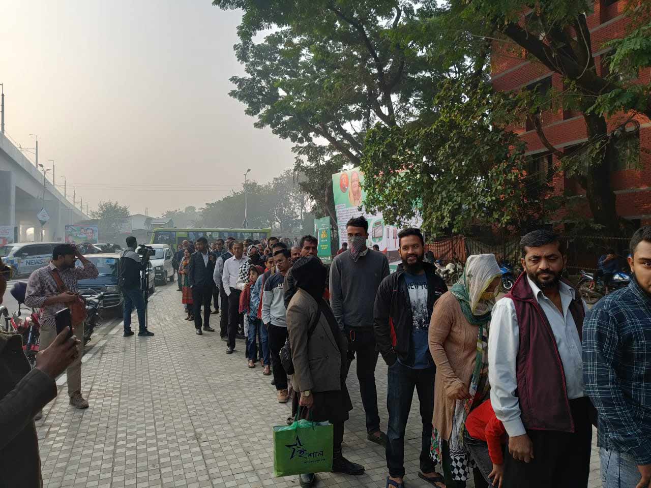 Passengers wait in long queues to ride metro rail