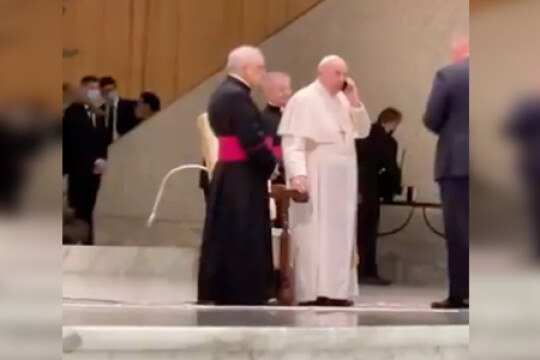 Watch: Pope breaks protocol, receives cellphone at public event